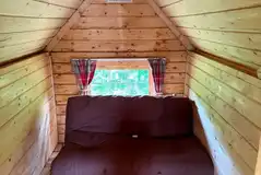 Wooden eco house interior with a sofa bed/futon (please bring bedding) Wooden eco house interior with a sofa bed/futon (please bring bedding)
