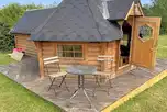 Glamping cabin with an outdoor picnic bench at Barley Fields Holidays