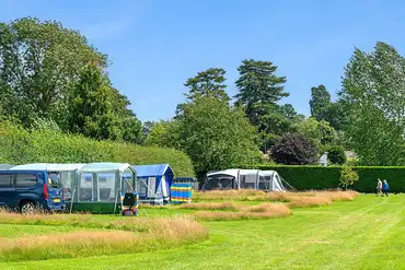 Grass tent pitches with natural long grass borders