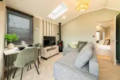 Snug cabin with an L-shaped sofa, TV, dining area and wood burner Snug cabin with an L-shaped sofa, TV, dining area and wood burner