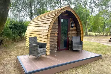 Wooden camping pod with a small deck area