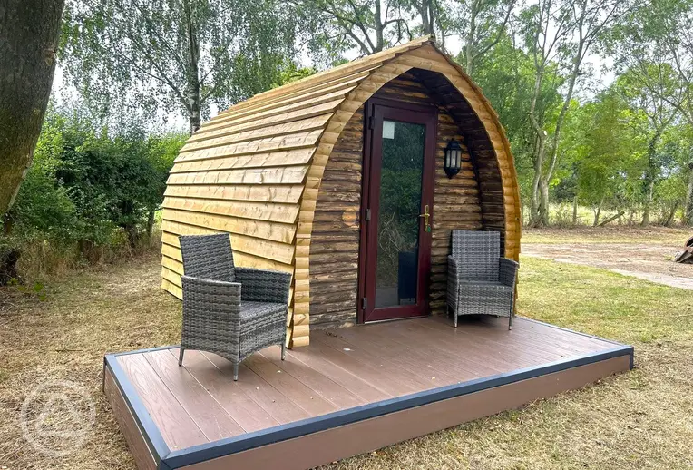 Wooden camping pod with a small deck area