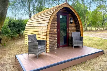 Wooden camping pod with a small deck area