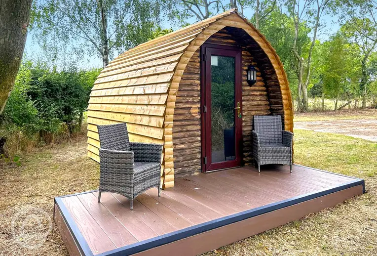 Wooden camping pod with a small deck area