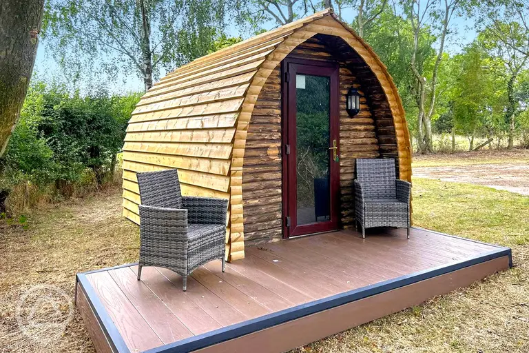 Wooden camping pod with a small deck area