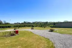 Grass and gravel hardstanding touring pitches (10m x 10m) Grass and gravel hardstanding touring pitches (10m x 10m)