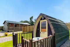Camping pod and small deck area with outdoor furniture Camping pod and small deck area with outdoor furniture