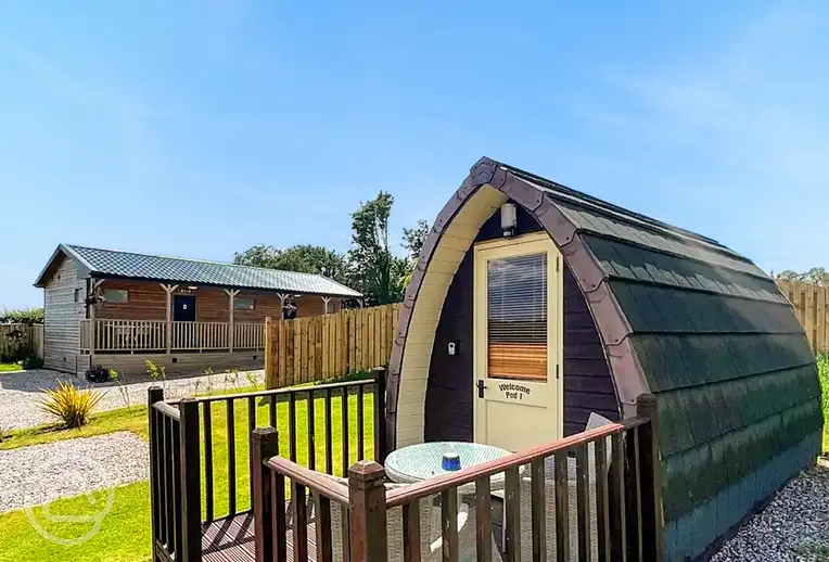 Camping pod and small deck area with outdoor furniture