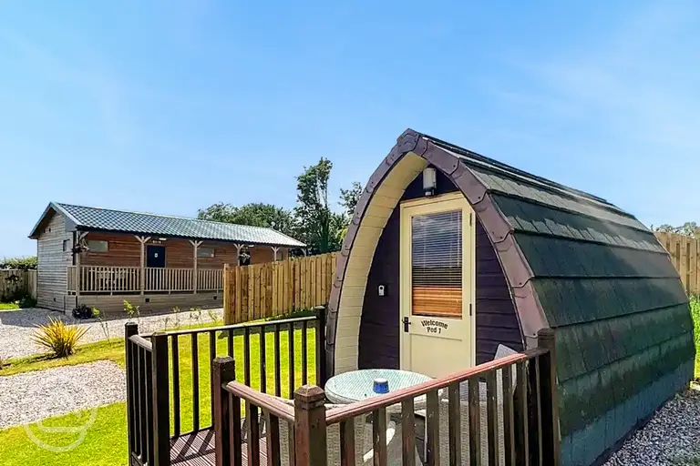 Camping pod and small deck area with outdoor furniture