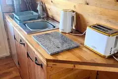 Camping pod kitchen with a kettle, microwave, sink and toaster Camping pod kitchen with a kettle, microwave, sink and toaster