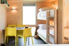 Camping cabins with a bunk bed and seating area