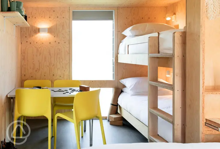 Camping cabins with a bunk bed and seating area