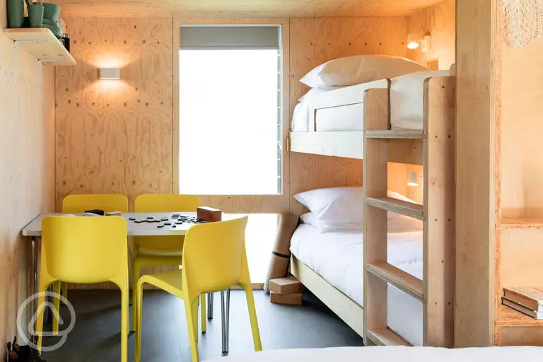 Camping cabins with a bunk bed and seating area