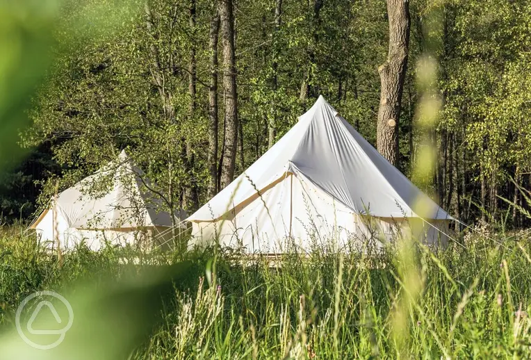 Bell tents on a wooden platform at Meadowfields Campsite