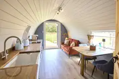 Waters Edge pod living, dining and kitchen area with a smart TV