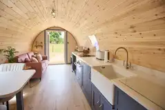 Meadow Spa pod living, dining and kitchen area with a smart TV