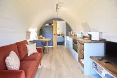 Waters Edge pod living, dining and kitchen area with a smart TV