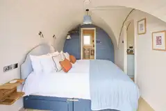 Waters Edge king size bedroom with bedding and an ensuite bathroom