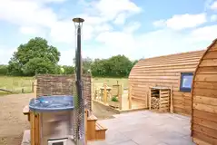 Meadow Spa pod with a wood-fired hot tub and wood supply