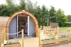 Meadow Spa pod with a roped off decking area and outdoor seating
