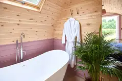 Meadow Spa king size bedroom with a free-standing bath tub