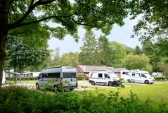 Hardstanding touring pitches with room for awnings and grass surrounds Hardstanding touring pitches with room for awnings and grass surrounds
