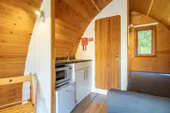Four person pod kitchen with a sink, microwave, fridge, kettle
