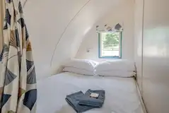 The Wonneys pod with a king bed and privacy curtain The Wonneys pod with a king bed and privacy curtain