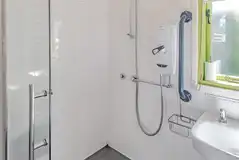 Humbleton accessible wet room with grab rails and a shower chair Humbleton accessible wet room with grab rails and a shower chair