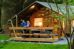 Safari tents at night with outdoor lighting