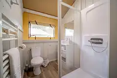 Safari tent ensuite bathroom with toilet, shower, sink and heated towel rail Safari tent ensuite bathroom with toilet, shower, sink and heated towel rail