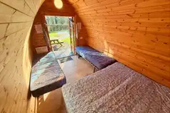 Camping pod with a double bed and two singles