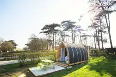 Wooden camping pods with a private picnic bench
