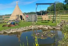 Tipi with pond views and swing seat