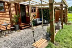 Willow glamping lodge outdoor area and swing Willow glamping lodge outdoor area and swing