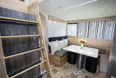 Glamping cabin dining area and steps to mezzanine level