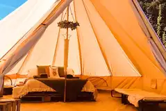 Sorrel bell tent in a private glade with a double bed and camp beds