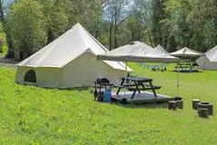 Furnished bell tents with private sheltered seating and a fire pit Furnished bell tents with private sheltered seating and a fire pit