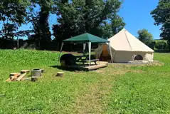 Furnished bell tents with private sheltered seating and a fire pit Furnished bell tents with private sheltered seating and a fire pit