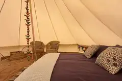 Bell tent with a double bed and bedding Bell tent with a double bed and bedding