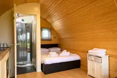 Glamping pod with a double bed, ensuite and kitchen