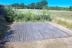 Grass pitch with decking area Grass pitch with decking area