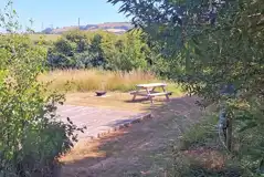 Grass pitch with decking, fire pit, picnic bench and private toilet Grass pitch with decking, fire pit, picnic bench and private toilet
