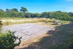 Grass pitch with decking area Grass pitch with decking area