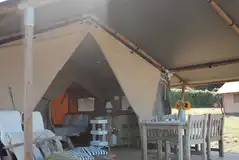 Safari tent exterior with outdoor seating Safari tent exterior with outdoor seating