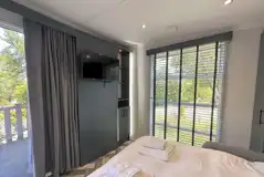 Hideaway pod interior with a double sofa bed and TV