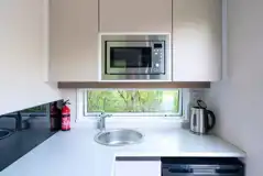 Hideaway pod kitchen with hob, grill, microwave, fridge, toaster and kettle