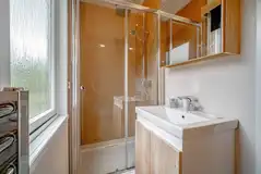 Family hideaway ensuite bathroom with shower and heated towel rail