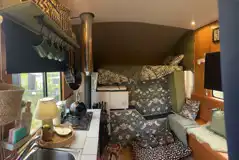 Converted horsebox living area with a single bunk over the cabin