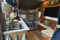 Converted horsebox living area with a single bunk over the cabin